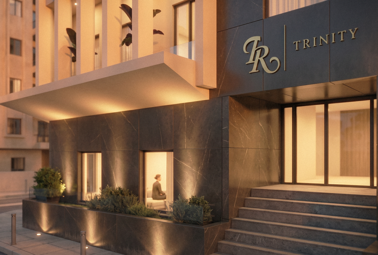 Trinity residential building entrance at dusk with signage
