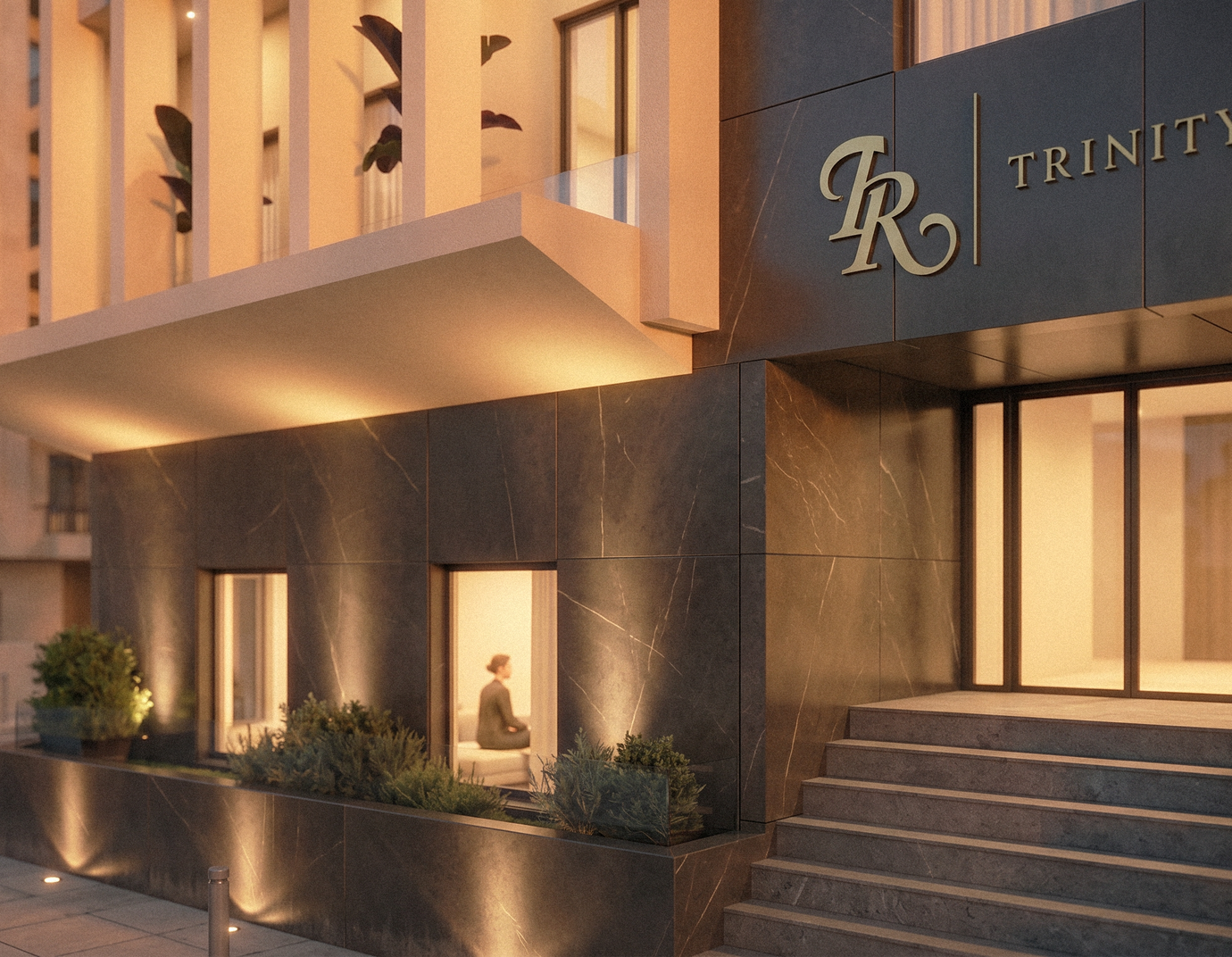 Trinity residential building entrance at dusk with signage